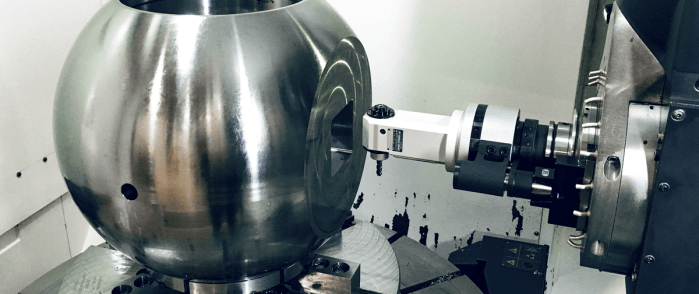 A 90 degree angle head entering a spherical workpiece.